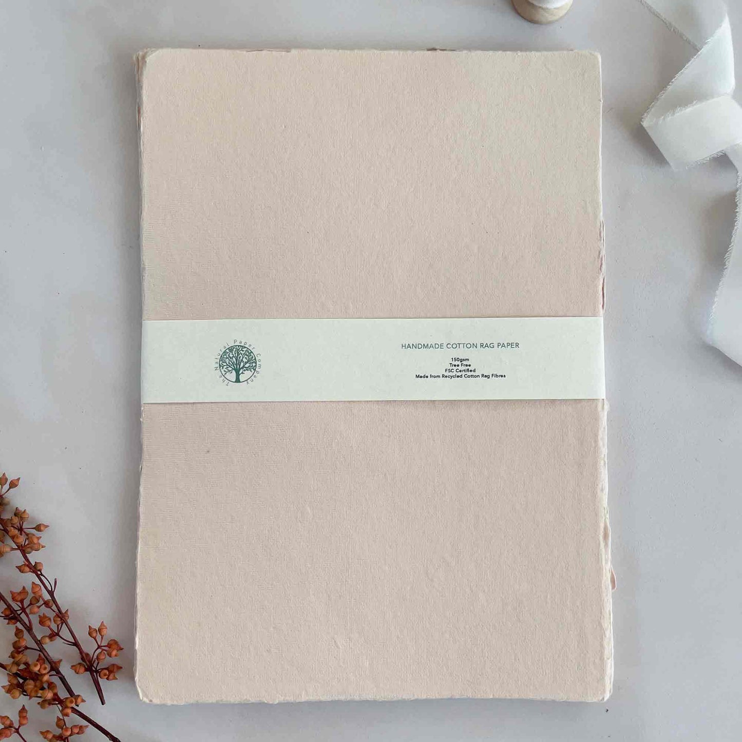 A4 sheets of handmade cotton rag paper in blush pink.  Deckle edge paper and card by The Natural Paper Company.