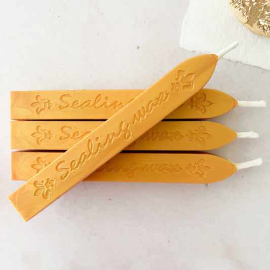 mustard yellow sealing wax.  Sealing wax stick with wick.  Mustard wax for making wax seals and stamps