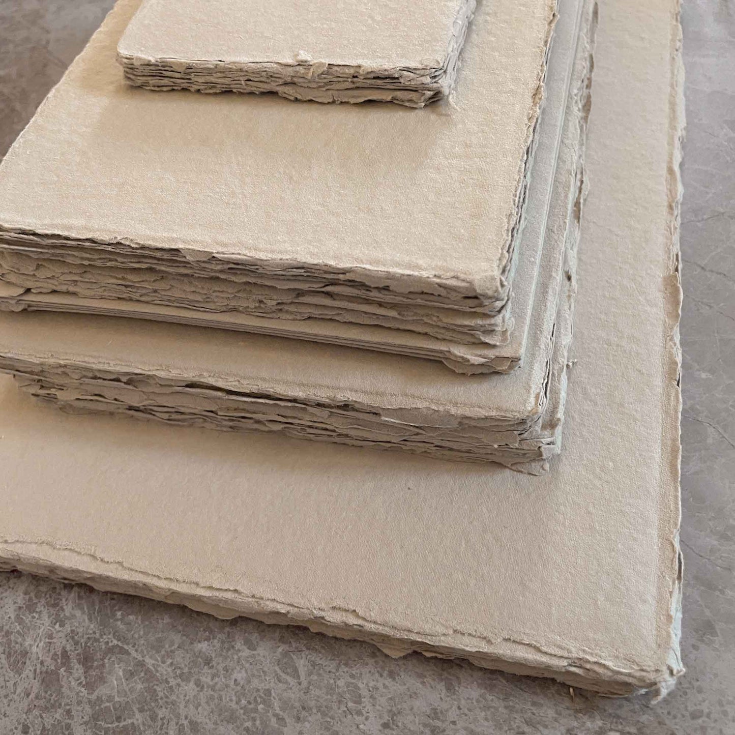 deckle edge handmade paper made from recycled cotton rag fibres in a natural colour