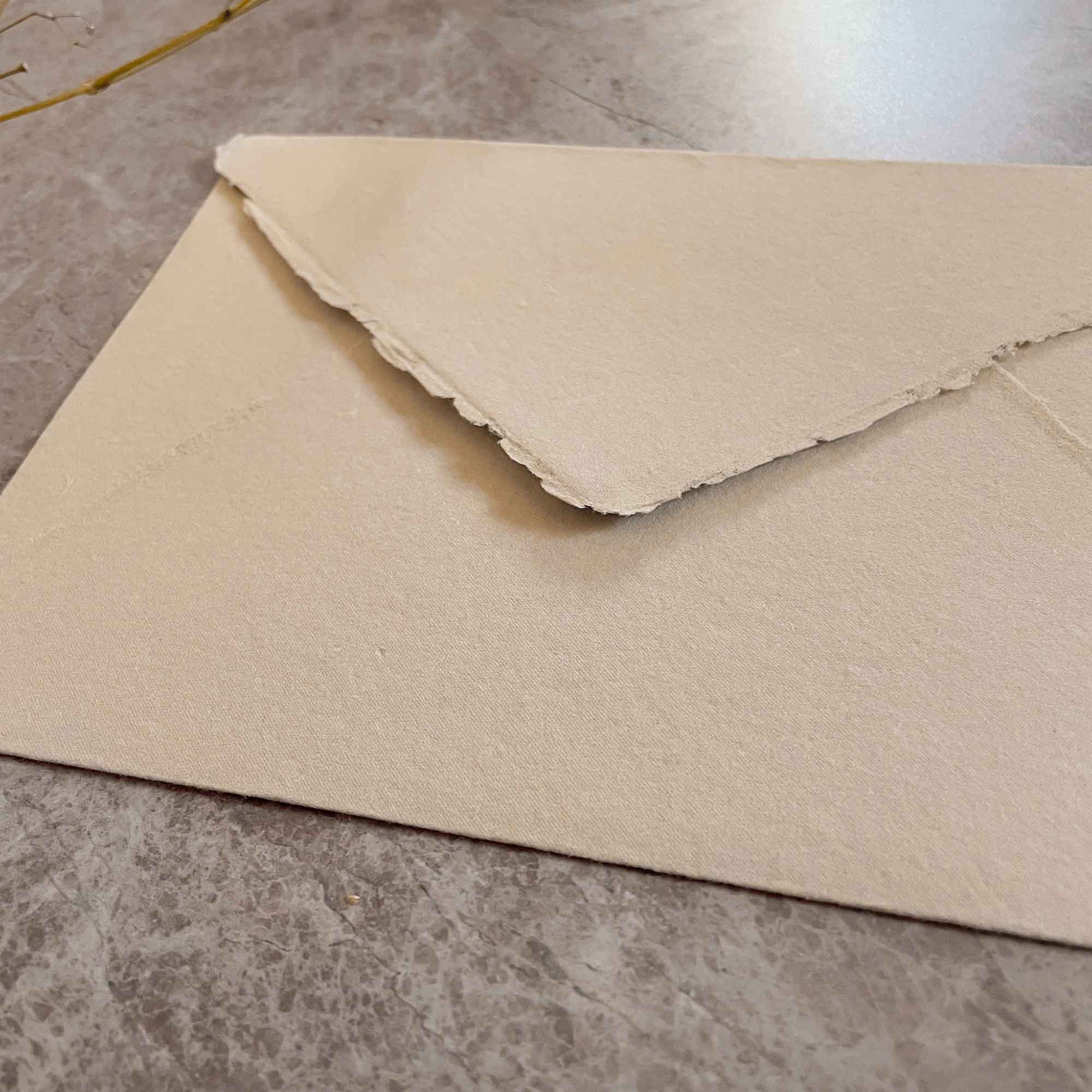 Handmade envelope made from recycled cotton rag paper with deckled edges