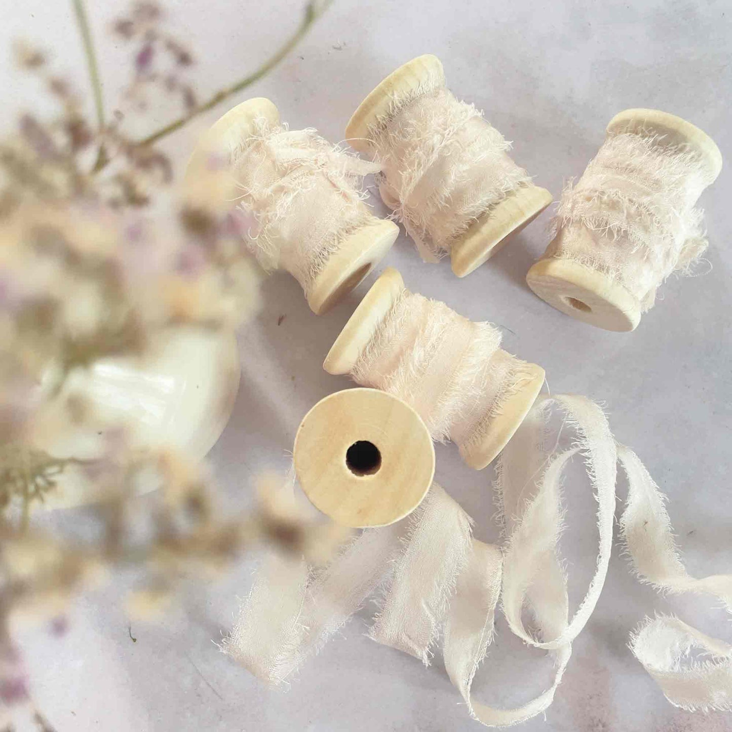 natural cream silk ribbon on a wooden reel.  1cm wide.  By The Natural Paper Company