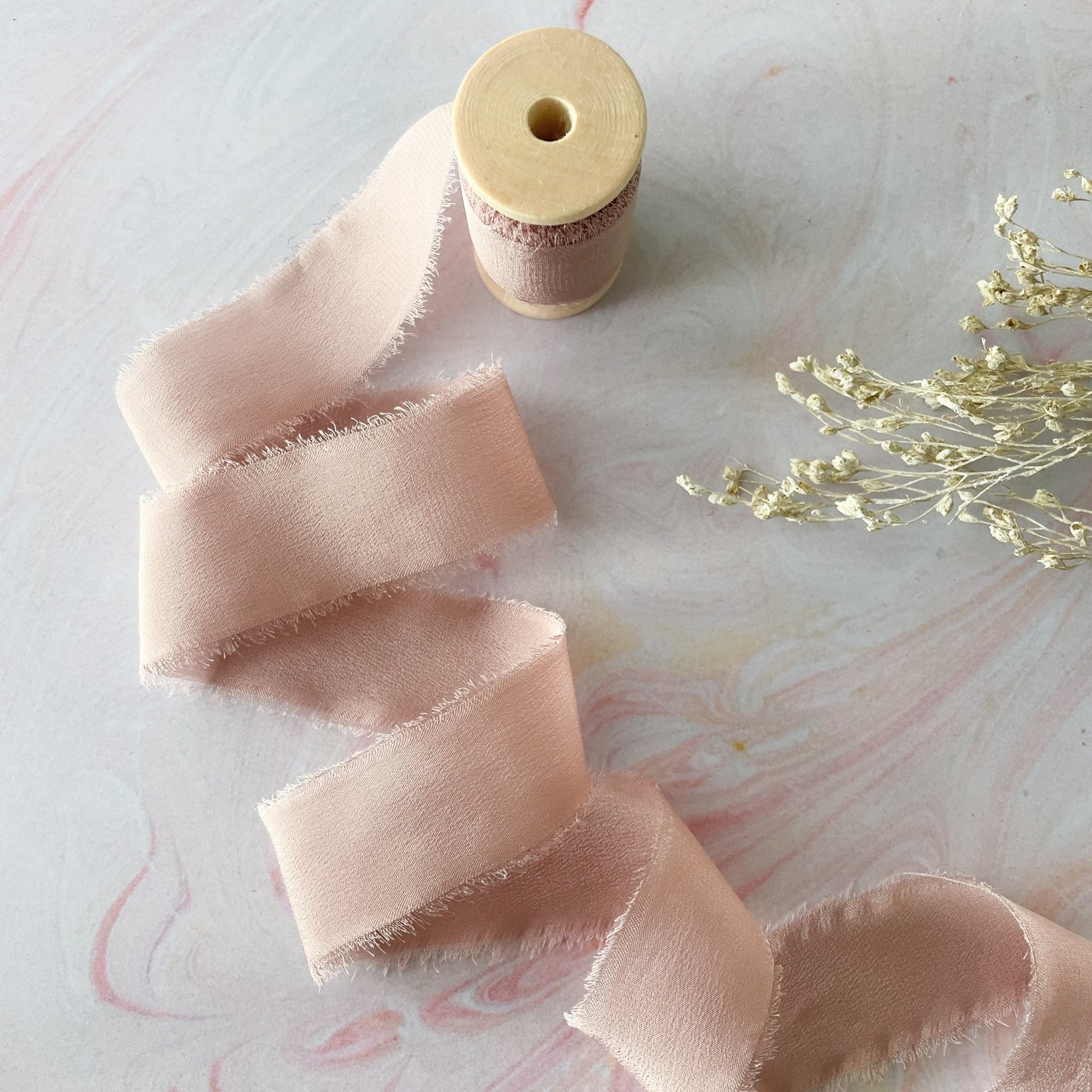 Luxury silk ribbon in nude pink colour.  Decorative ribbon with frayed edges.  By The Natural Paper Company.