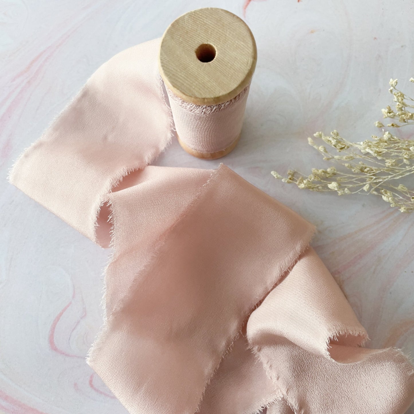 Nude pink silk ribbon for crafts.  Fine habotai silk ribbon with a raw edge.  Perfect ribbon to decorate wedding invitations, stationery, crafts and floristry.  By The Natural Paper Company.  