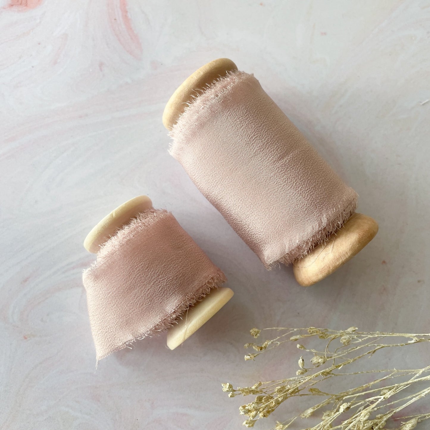 Nude blush silk ribbon.  Luxury silk ribbon on a wooden reel.  Available in wide or narrow lengths.  Habotai silk ribbon on a wooden reel.  By The Natural Paper Company.