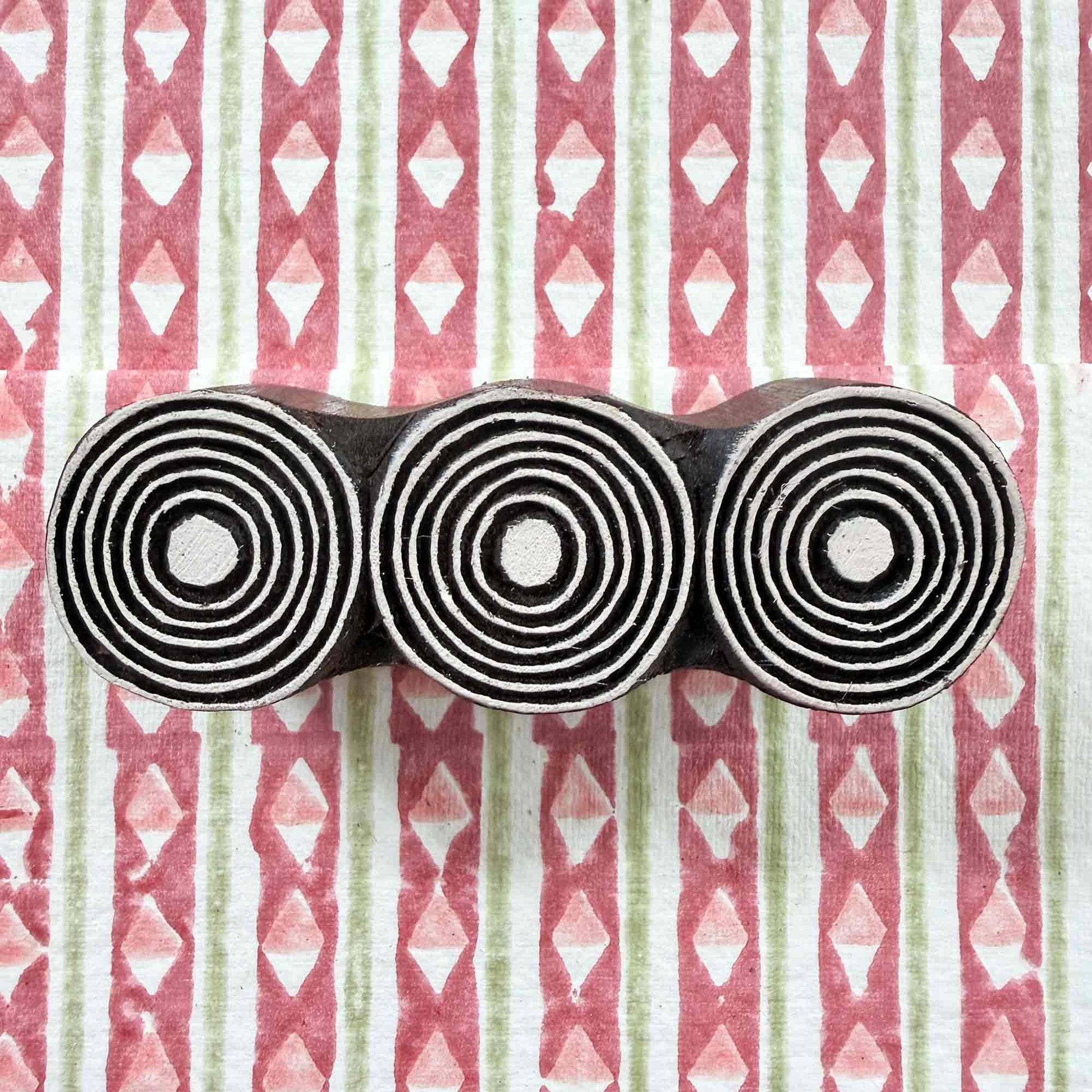 Orbits Indian wood block stamp — three symmetrical circles resting on rblock printed fabric, hand-carved border printing block