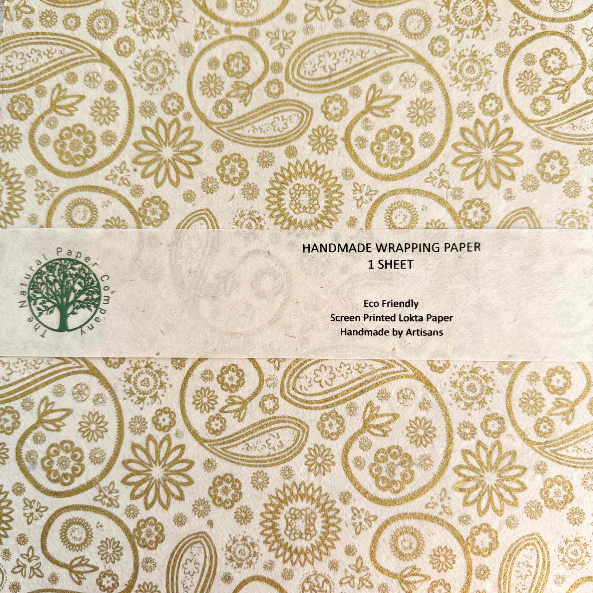 Handmade wrapping paper with gold floral and paisley patterns on a beige background, made from Lokta paper
