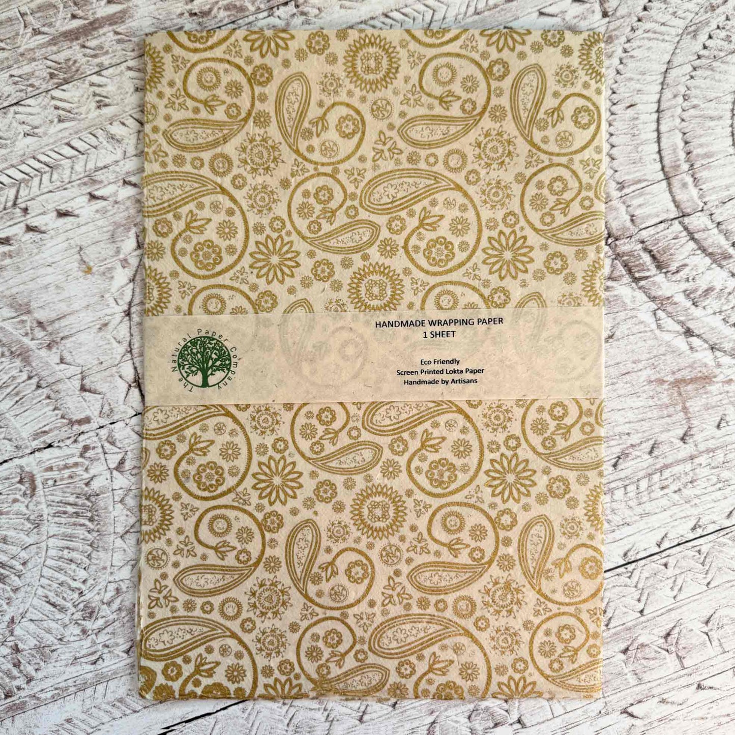 Handmade wrapping paper with paisley pattern in gold