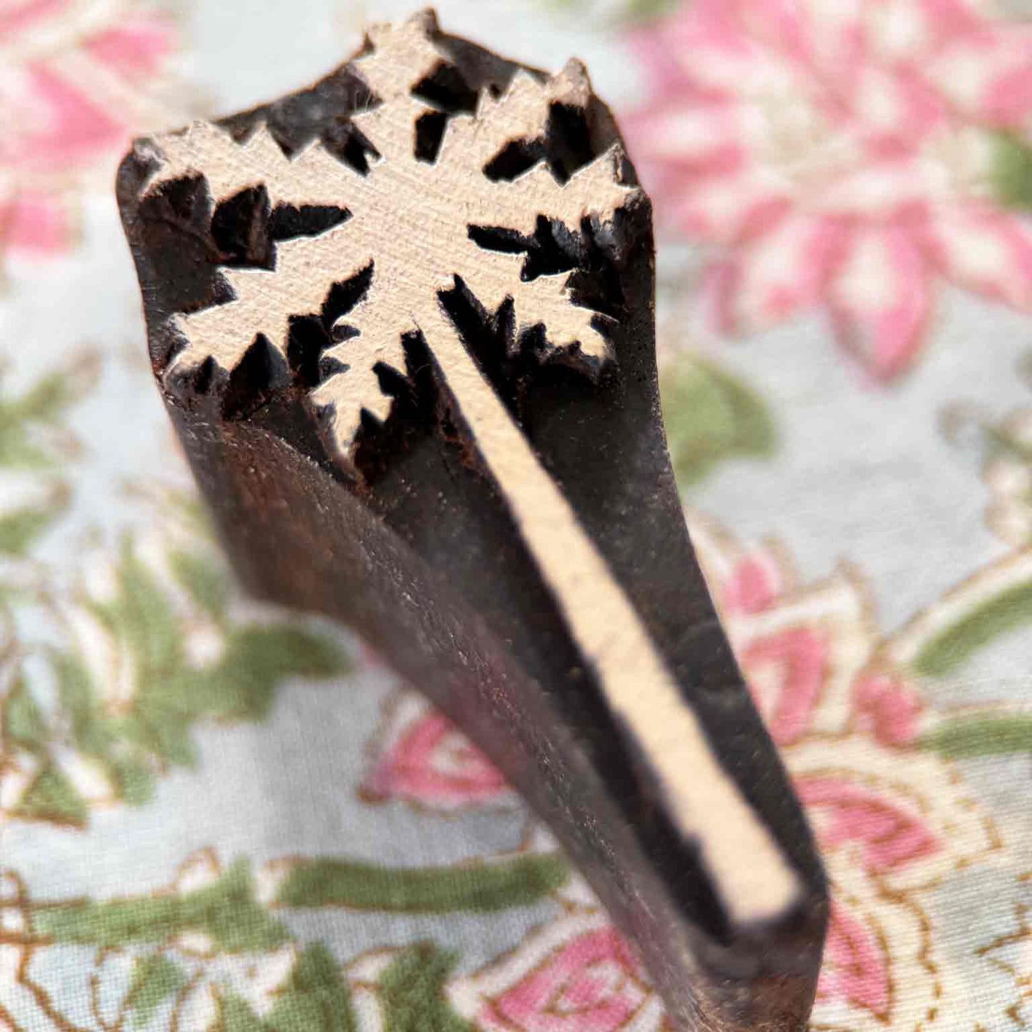 Hand-carved palm tree wooden stamp displayed on block printed fabric