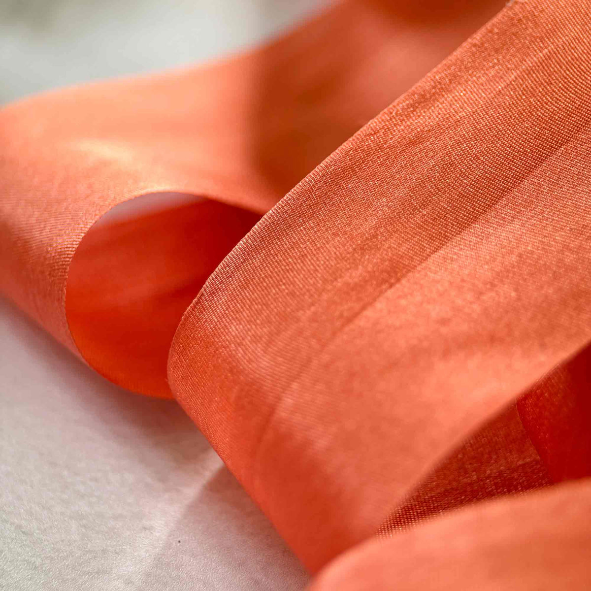 Close-up of 32.5mm Paprika Habotai Silk Ribbon showing its smooth texture and warm burnt orange colour.