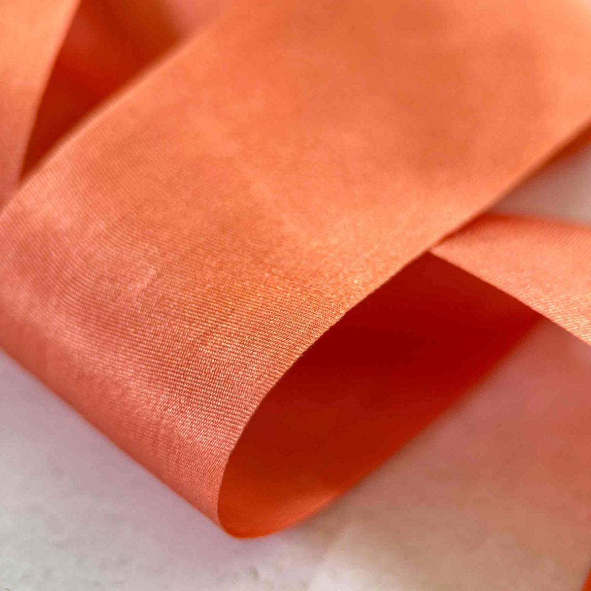 Paprika burnt orange Silk Ribbon showing the fine weave, natural sheen, and elegant closed edges.