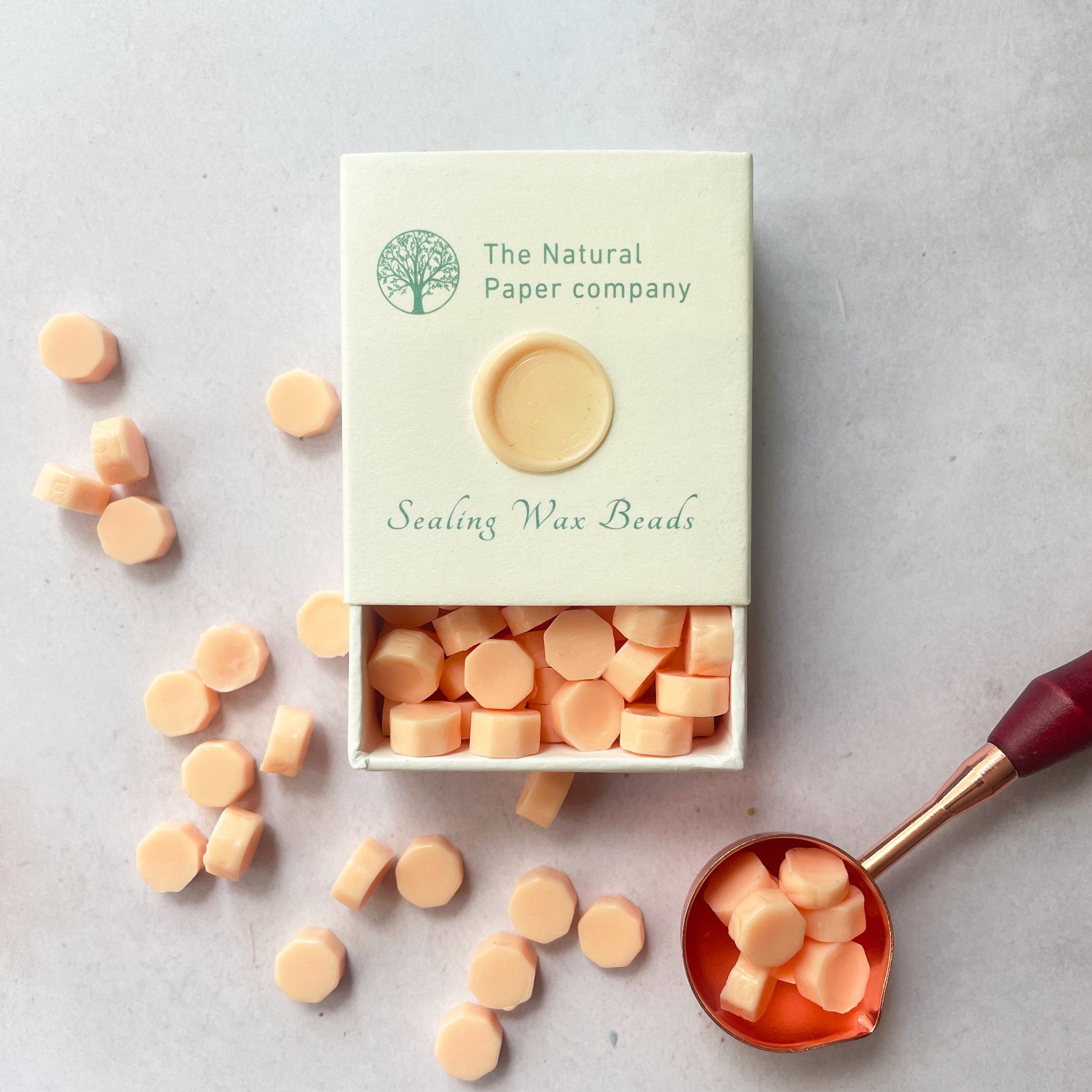 Peach colour sealing wax to make wax seals.  Box of eco friendly sealing wax beads to use with a melting spoon.  Make wax seals for invitations, stationery, gift wrapping or packaging.  By The Natural paper Company