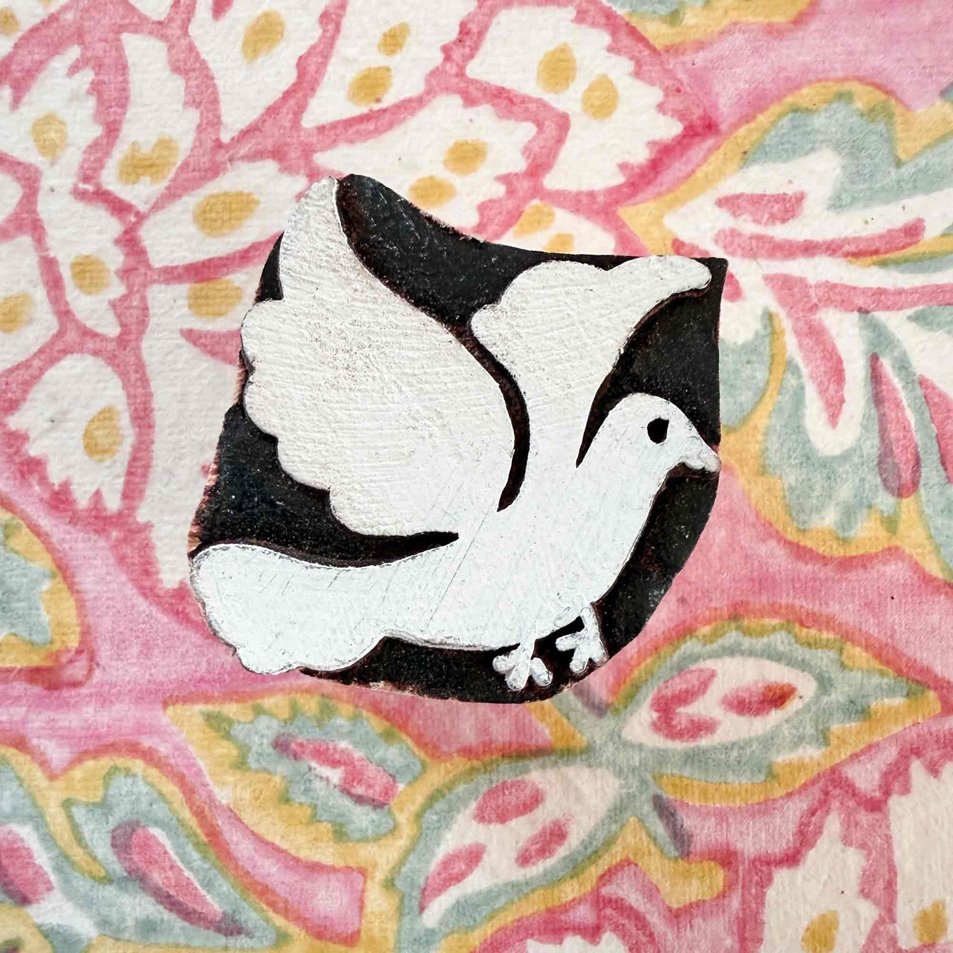 dove design wooden stamp on a woodblock pattern background