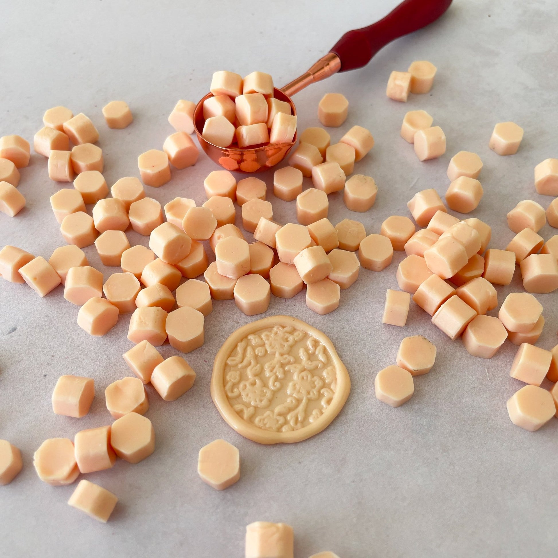 Make peach colour wax seals with eco friendly sealing wax beads.  Easy to use with a melting spoon.  by The Natural Paper Company