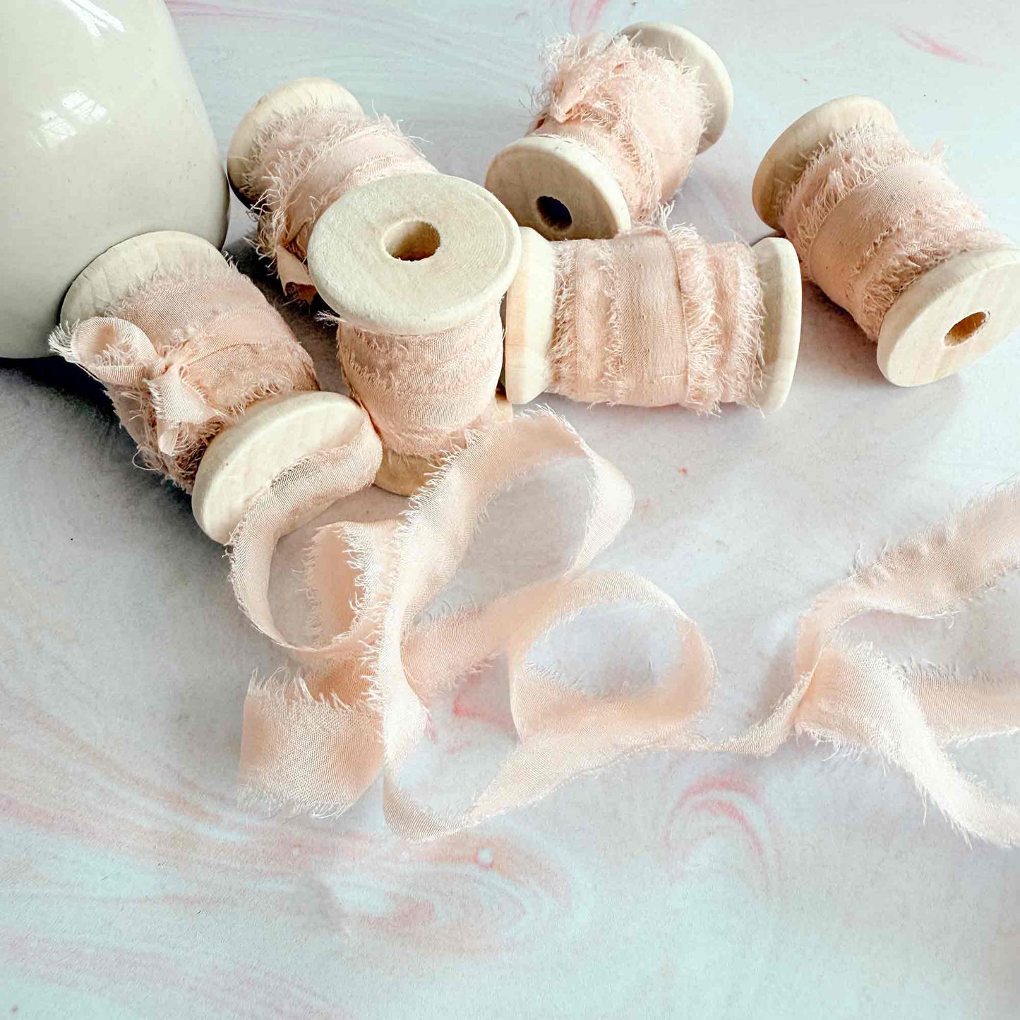 Light Peach silk ribbon with a raw edge.  Narrow silk ribbon for place cards and tags