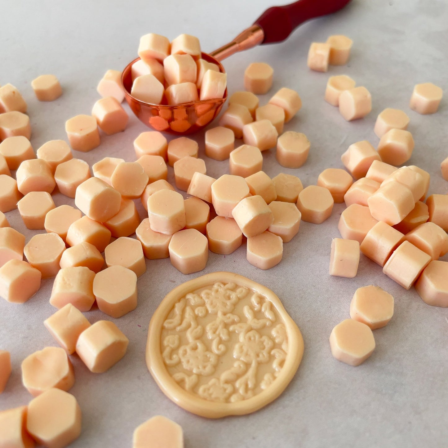 Eco friendly sealing wax beads in peach.  Wax to make wax seals.  by The Natural Paper Company