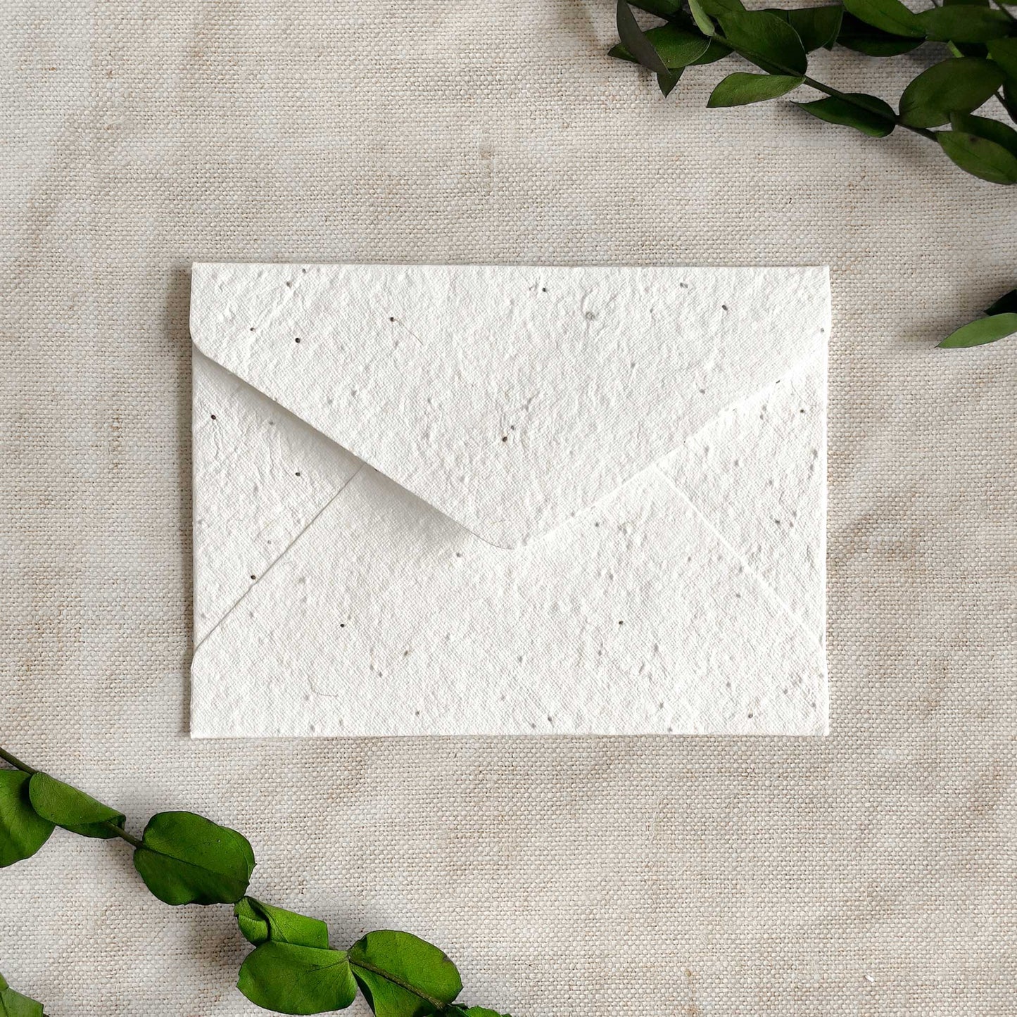 Handmade paper envelopes you can plant.  Basil seed plantable envelopes made from white handmade paper.  Invitation envelopes.  By The Natural Paper Company