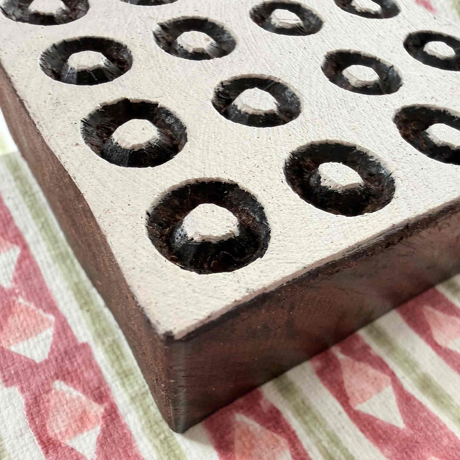 Polkas wooden stamp — ring dot grid design viewed from angle on block printed fabric, handcrafted Indian printing block with hollow centre dots