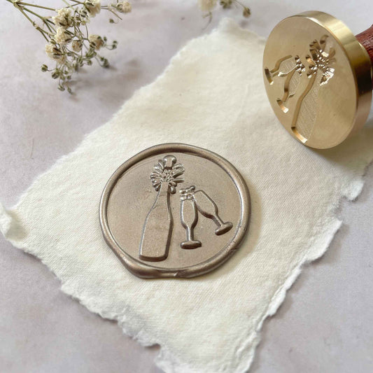 Pop The Cork Sealing Wax Stamp with Champagne Bottle and Glasses.  Celebratory wax seal stamp for invitations, and cards.  Brass wax stamp with a wooden handle.  By The Natural Paper Company