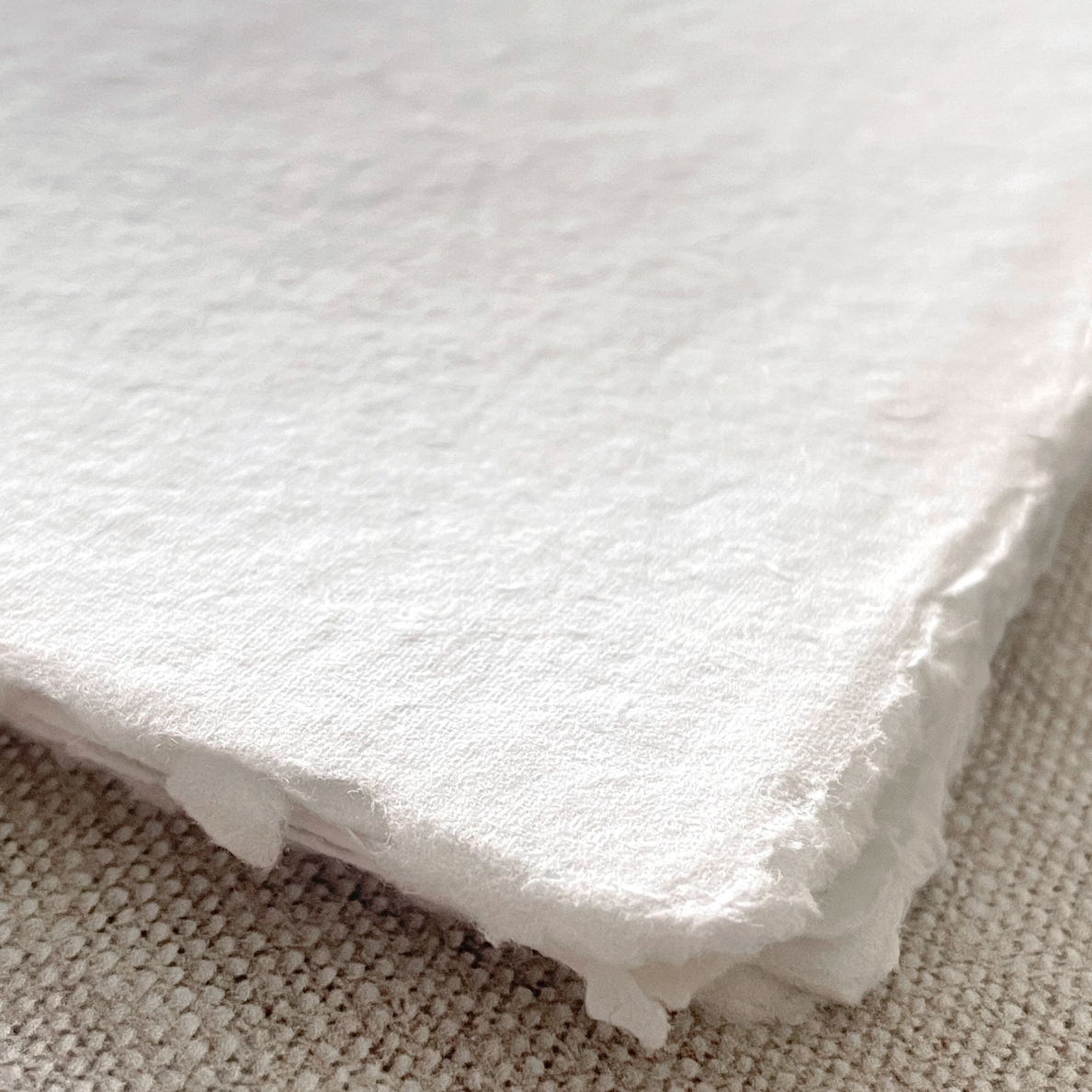 White handmade paper with a deckled edge.  Recycled cotton rag paper.  Vegan handmade paper for watercolour painting, crafts, calligraphy and invitations.   By The Natural Paper Company