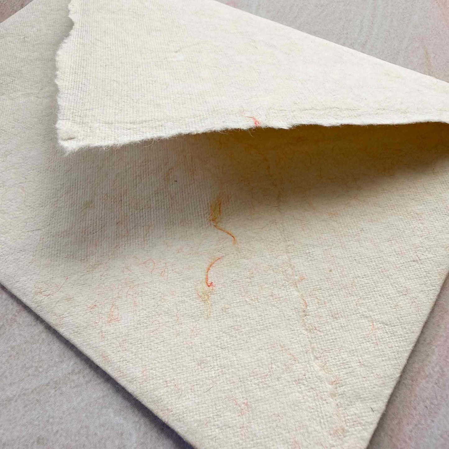 ivory handmade cotton paper envelope with decorative wool fibres