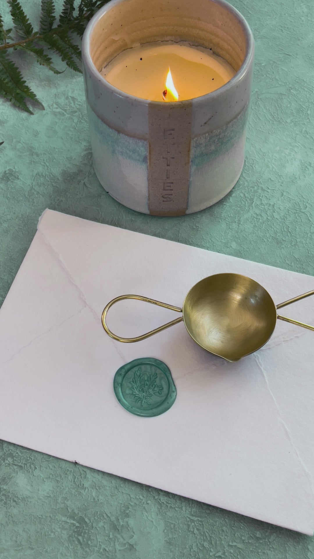 Make wax seals with a two handle melting spoon, sealing wax beads and a candle