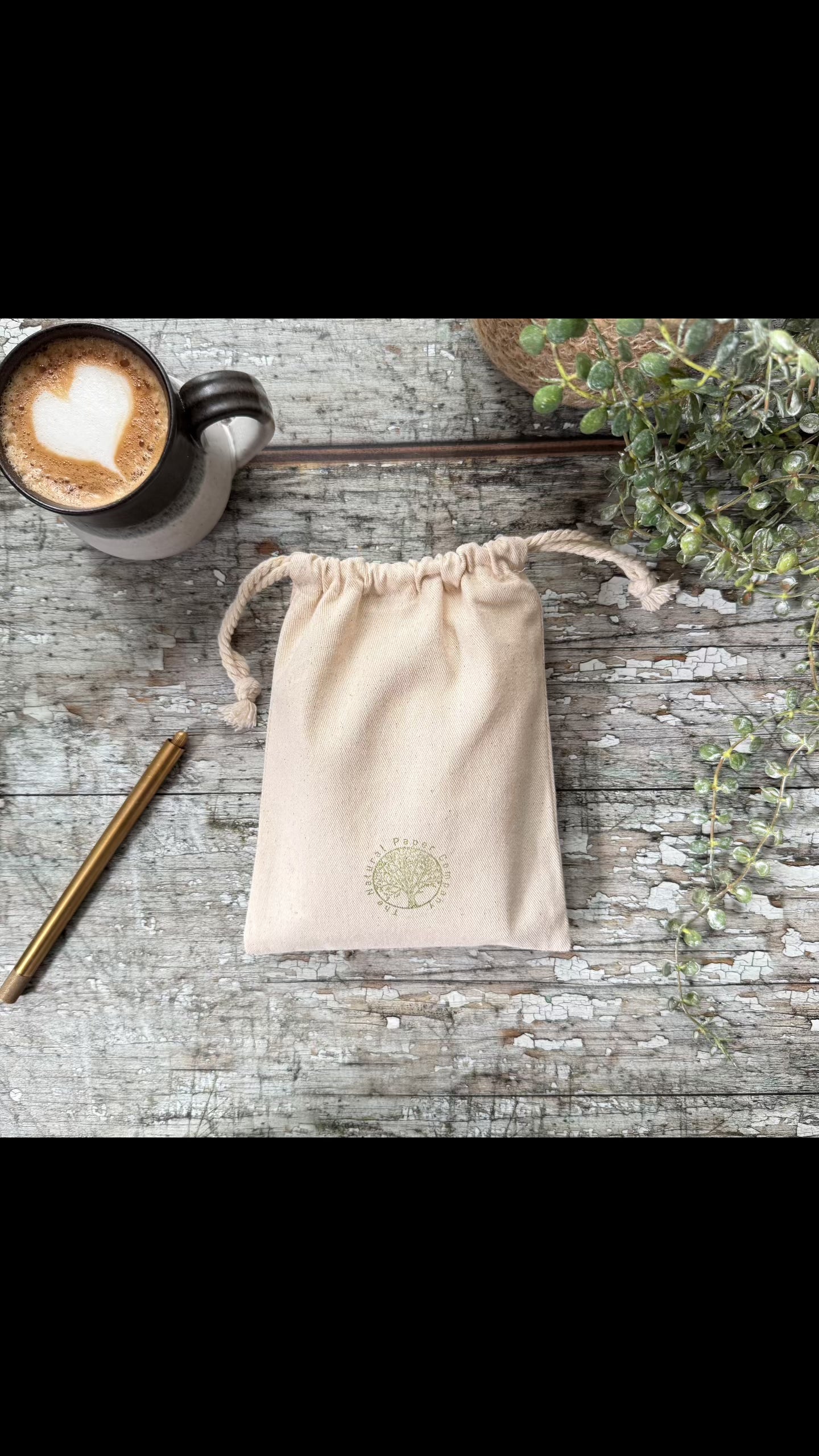 video of small ivory leather notebook in a gift bag