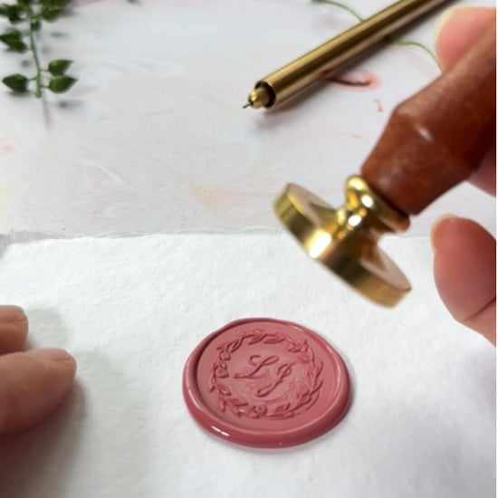video showing how to make custom wax seals with a customised sealing wax stamp