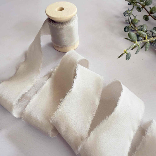 Putty colour silk ribbon with a frayed edge.  Neutral silk ribbon