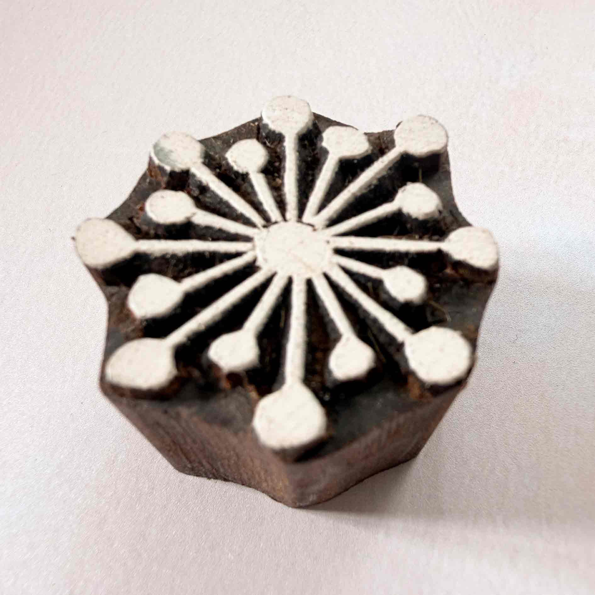 Radiance Indian wood block stamp — bright sunburst viewed from side, showing carved depth and smooth rounded ray tips, handcrafted hardwood printing block on neutral background