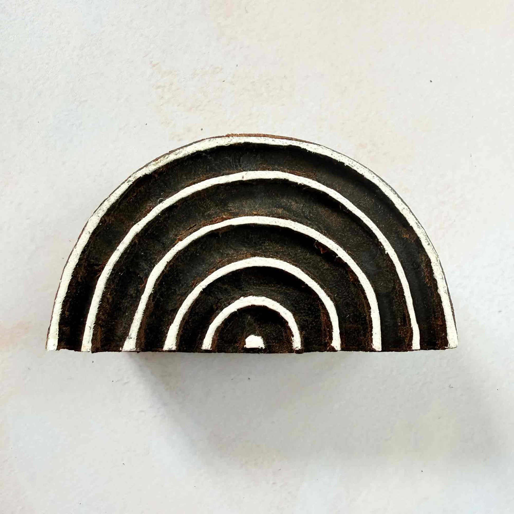 Rainbow Indian wood block stamp — symmetrical semicircular arch design face-on view, hand-carved traditional printing block on neutral background