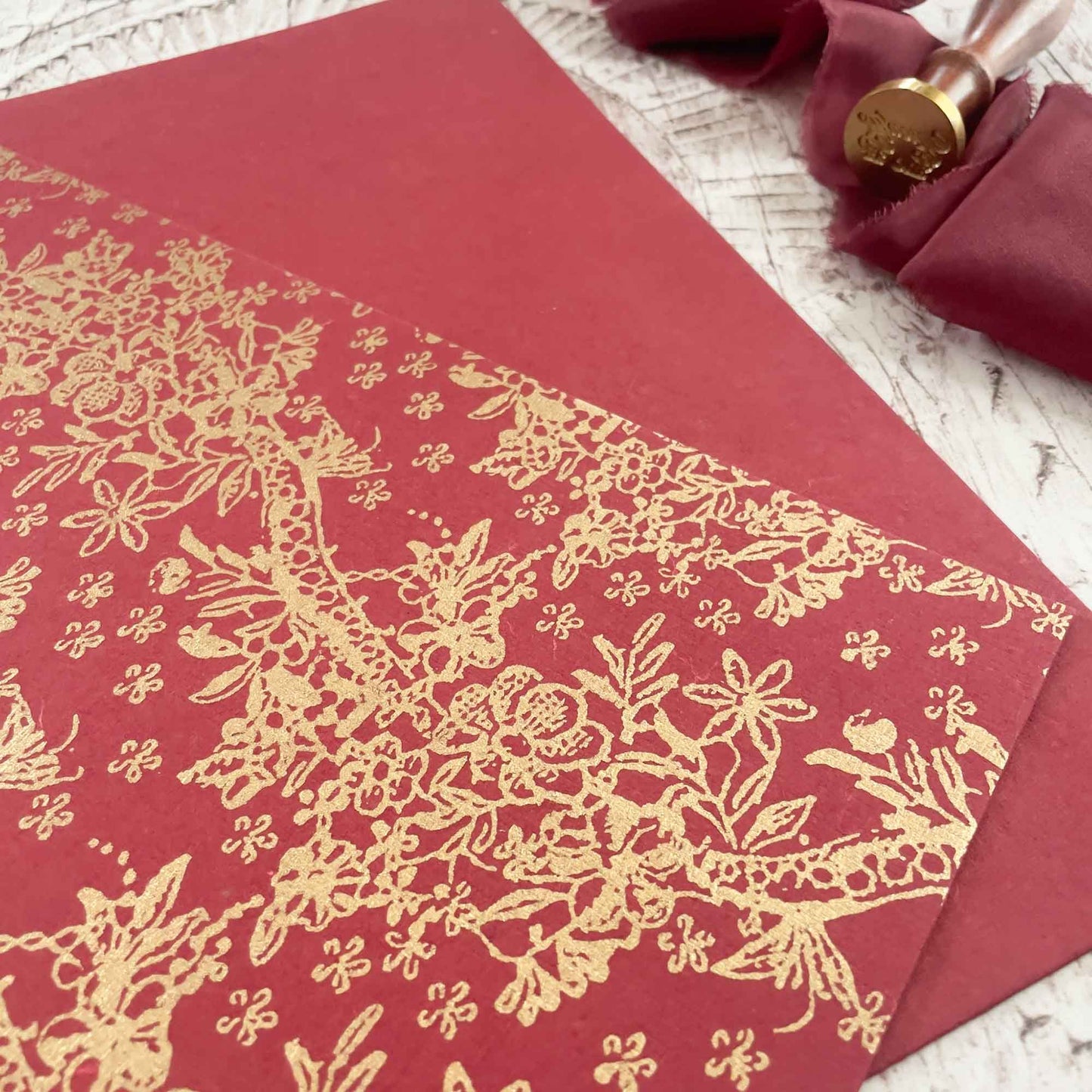 red recycled paper with gold pattern decoration