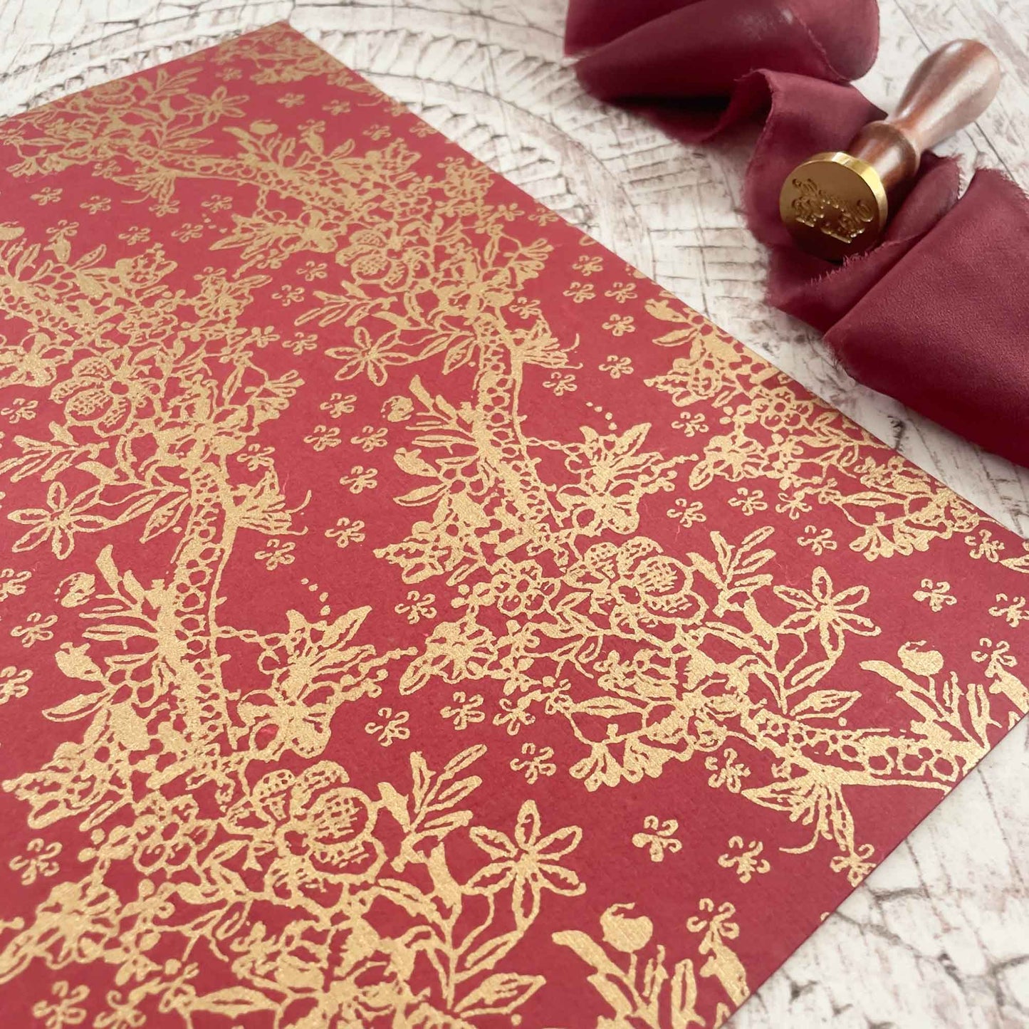 patterned recycled paper in red and gold.  