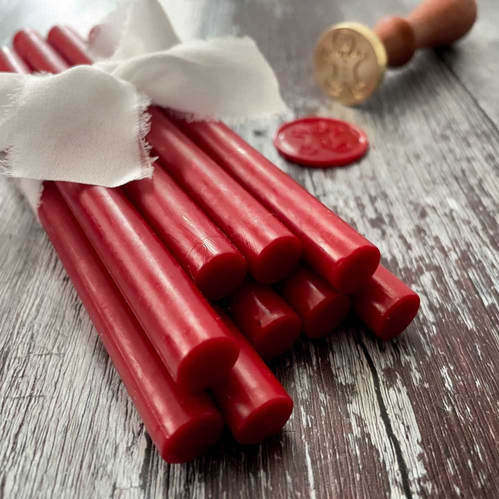 Bright red eco friendly sealing wax sticks.  Plastic free, paraffin free and biodegradable wax seals stick.  Can be used with a glue gun or melting spoon.  By The Natural Paper Company