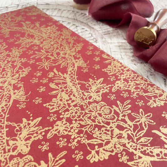 red and gold patterned paper made from recycled cotton rag