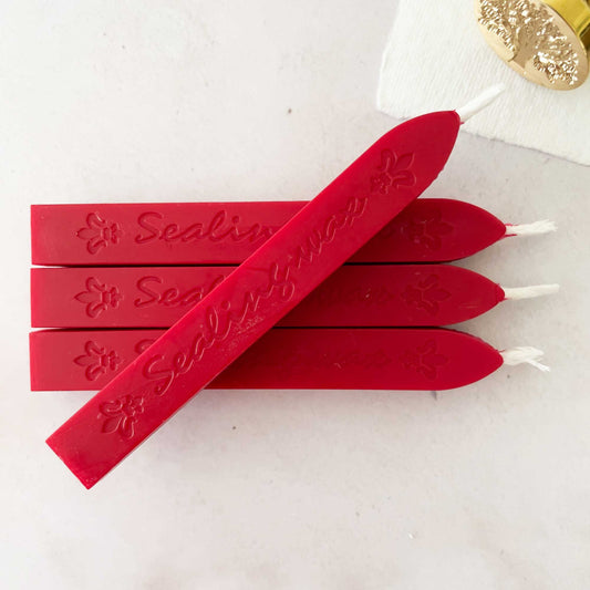 bright red sealing wax sticks with wick.  Traditional style sealing wax in bright red colour