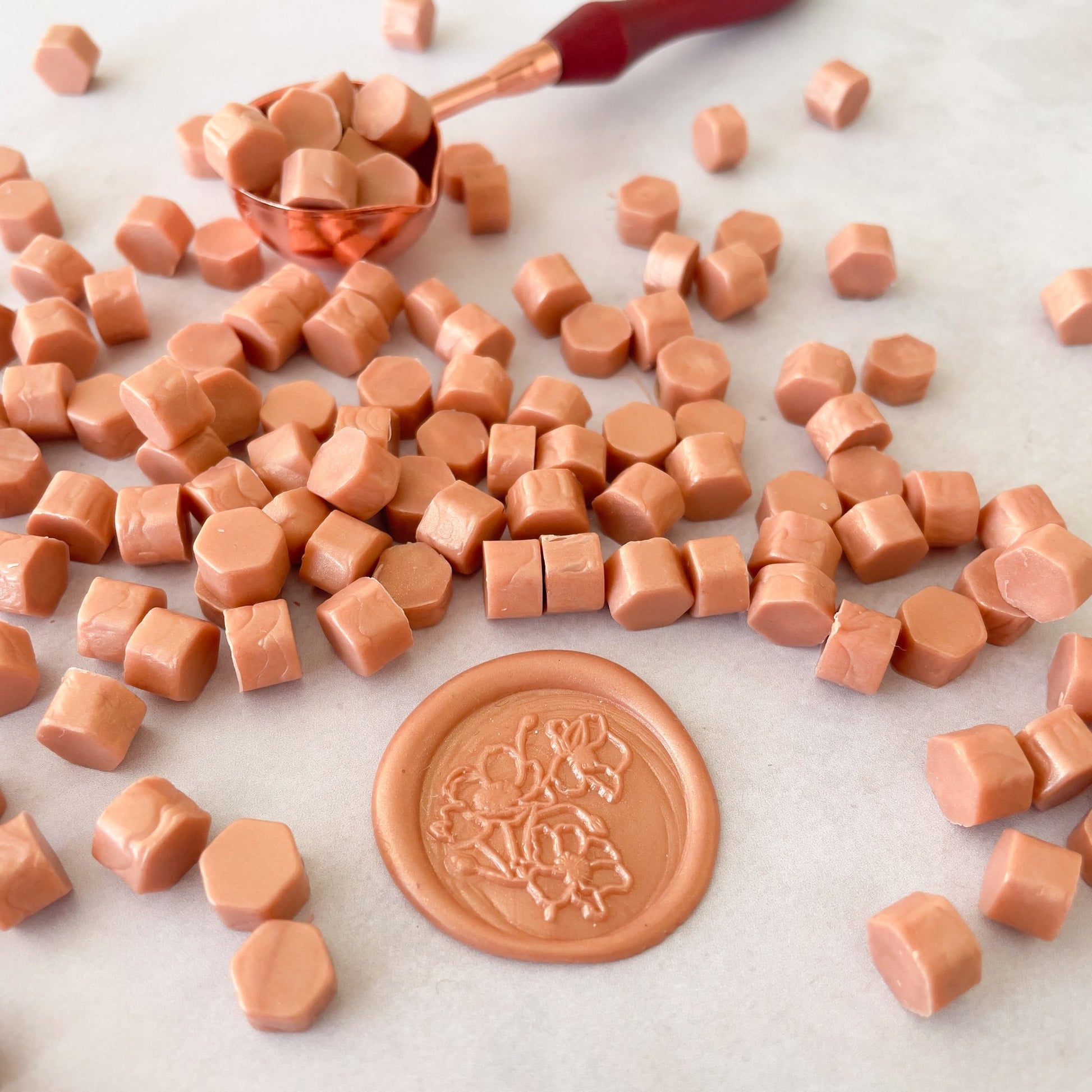 Rose gold sealing wax beads to make wax seals.  Eco friendly wax by The Natural Paper Company