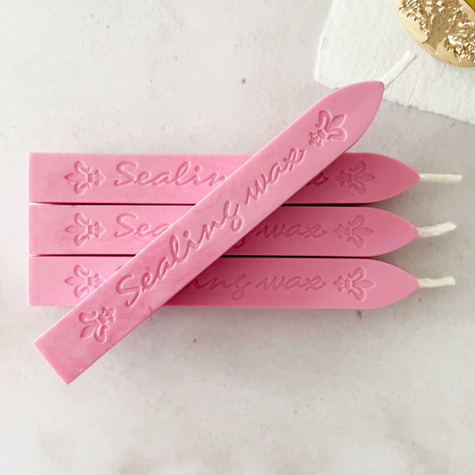 bright pink sealing wax sticks with wick.  Traditional sealing wax for wax stamps and seals