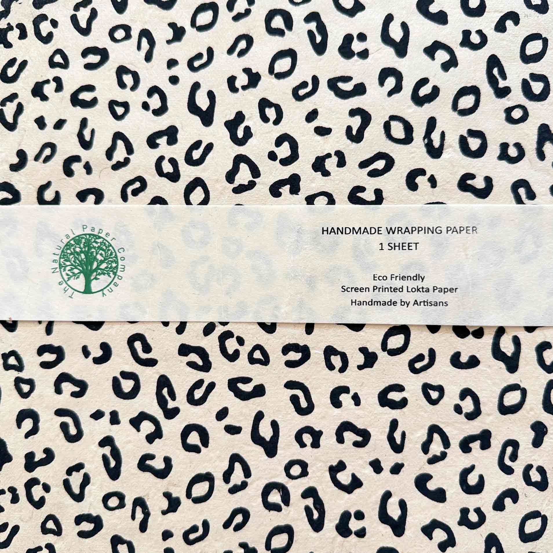 Close-up of leopard print Lokta wrapping paper sheet with product label – handmade eco-friendly gift wrap