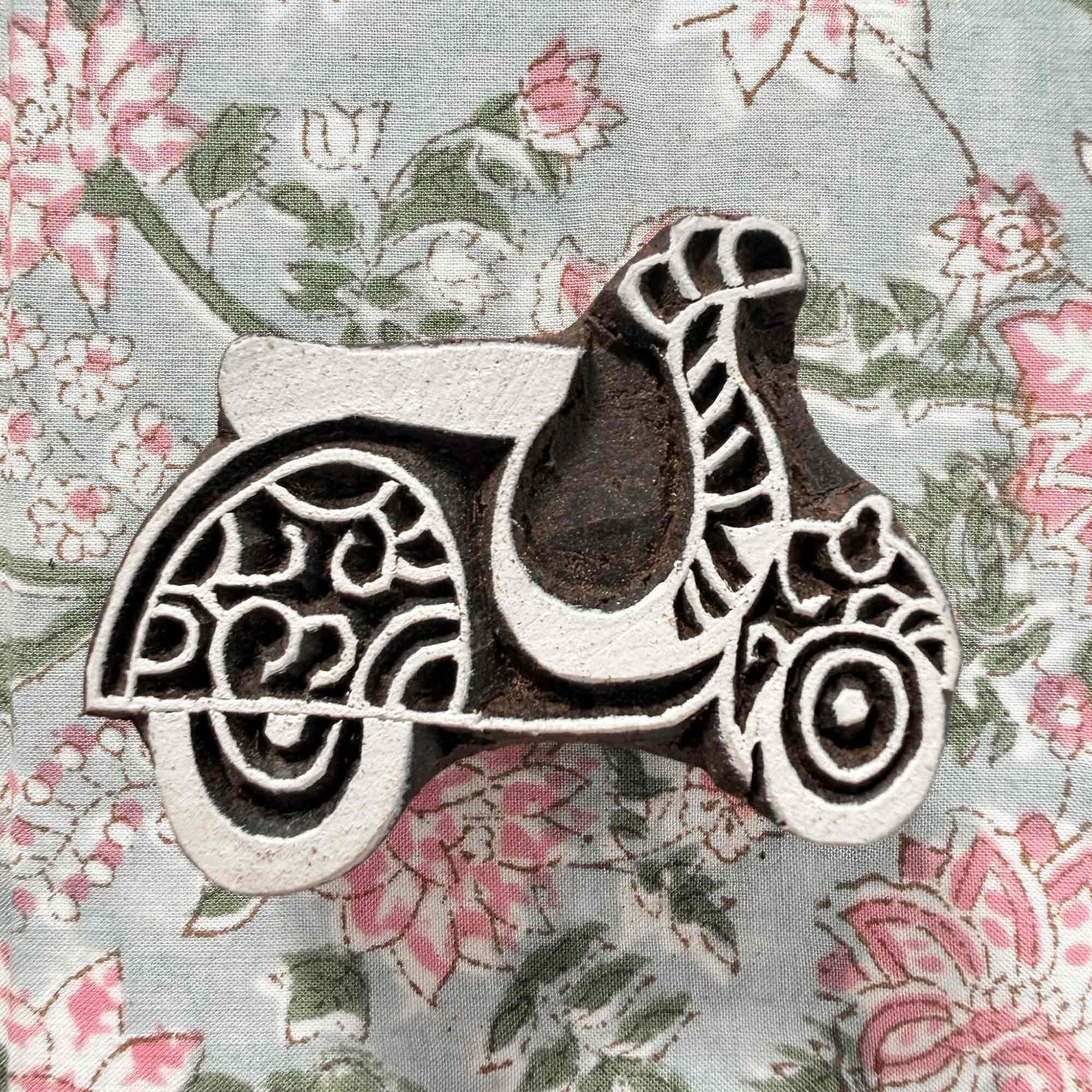 Indian wood block stamp — Scoot decorative scooter resting on floral block printed fabric, charming scooter design ready for printing, handcrafted wooden stamp, classic traditional printing block whimsical motif