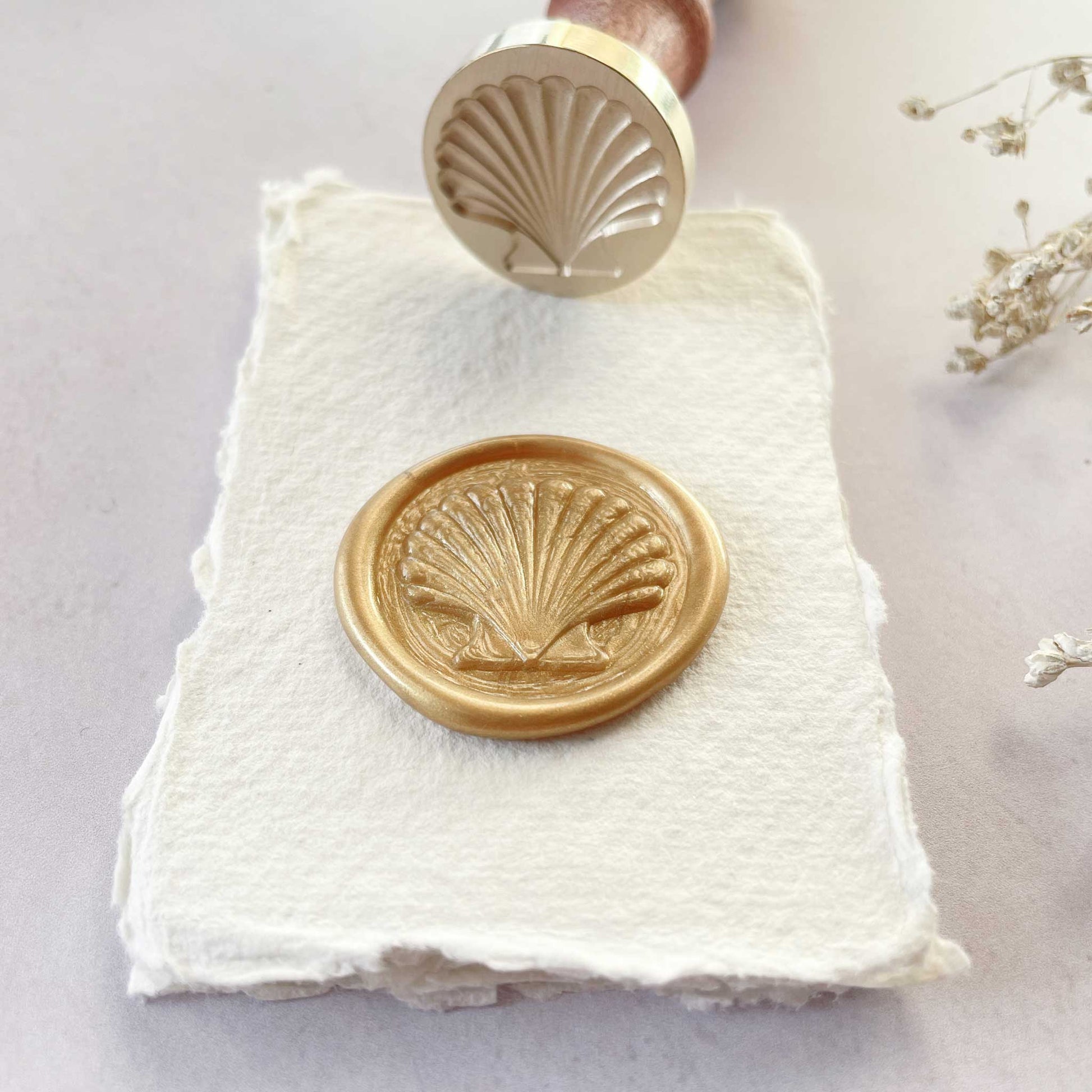 Wax stamp with a seashell design.  Coastal theme wax seal stamp for making beach theme wax seals.  Perfect for use with eco friendly sealing wax to decorate wedding invitations, stationery, envelopes and crafts.  By The Natural Paper Company 