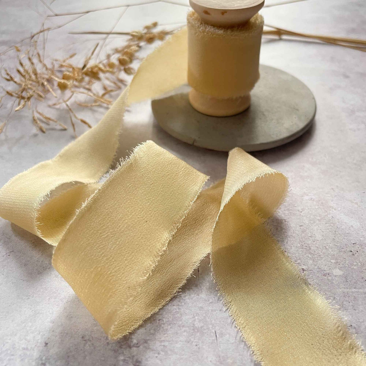 Buttermilk yellow silk ribbon with a frayed edge.  Fine silk ribbon for crafts.  By The Natural Paper Company