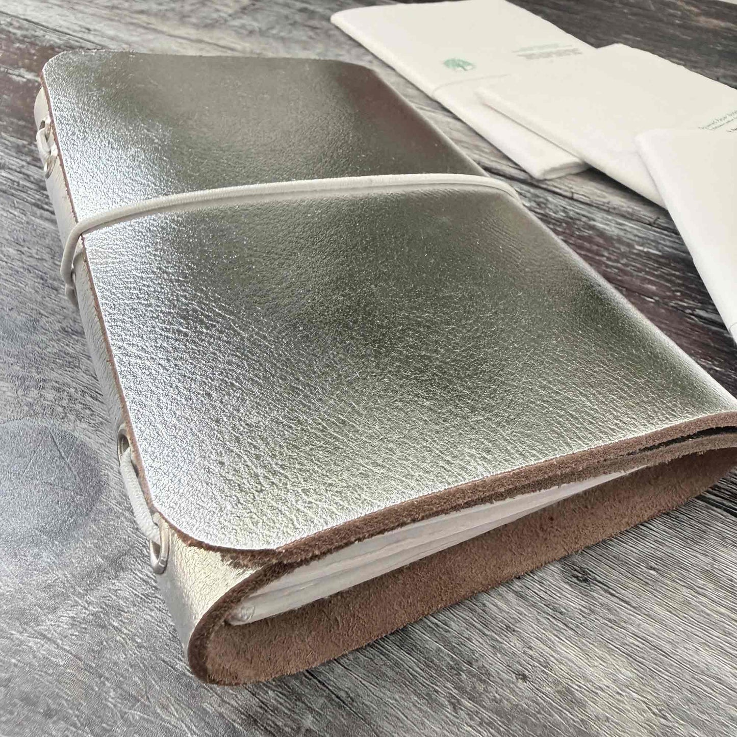 A6 silver leather journal — compact travel‑friendly refillable notebook
