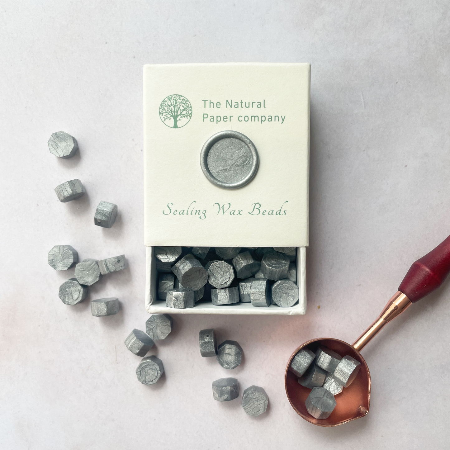 Silver sealing wax beads to make wax seals.  Box of small hexagon shaped wax beads.  Eco friendly wax seal wax.  Plastic free, paraffin free and biodegradable.  By The Natural paper Company