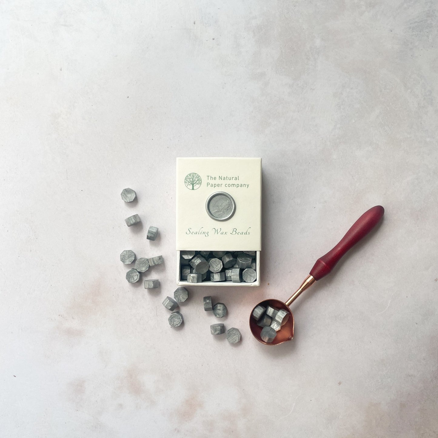 Eco Friendly sealing wax beads in metallic silver.  Small beads of wax to make wax seals.  Use with a melting spoon.  Plastic Free, Paraffin Free and Biodegradable sealing wax.  The Natural paper Company