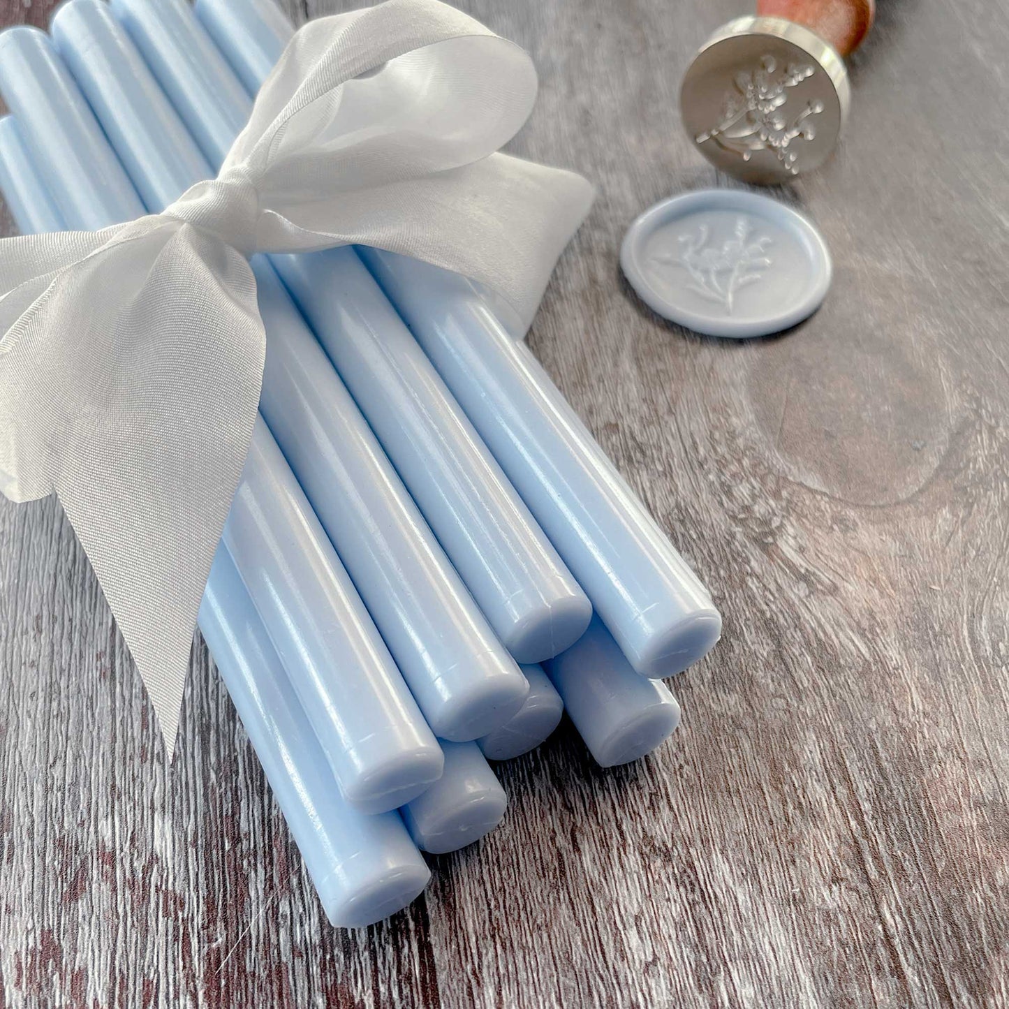 Light blue eco friendly sealing wax sticks By The Natural Paper Company.  Make light blue wax seals with our glue gun sealing wax.  This wax can also be used with a melting spoon.  Plastic free, paraffin free, biodegradable sealing wax sticks.  By The Natural Paper Company