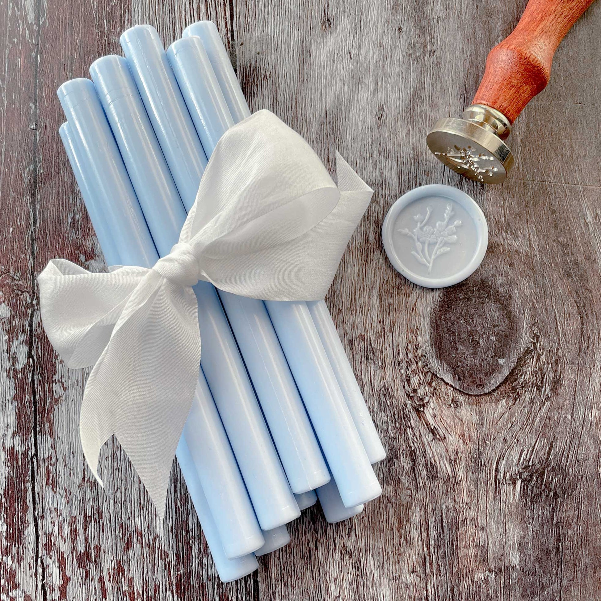 Eco friendly sealing wax sticks in sky blue.  Glue gun sealing wax in light blue colour.  Plastic free, paraffin free, biodegradable wax to make wax seals.  By The Natural Paper Company