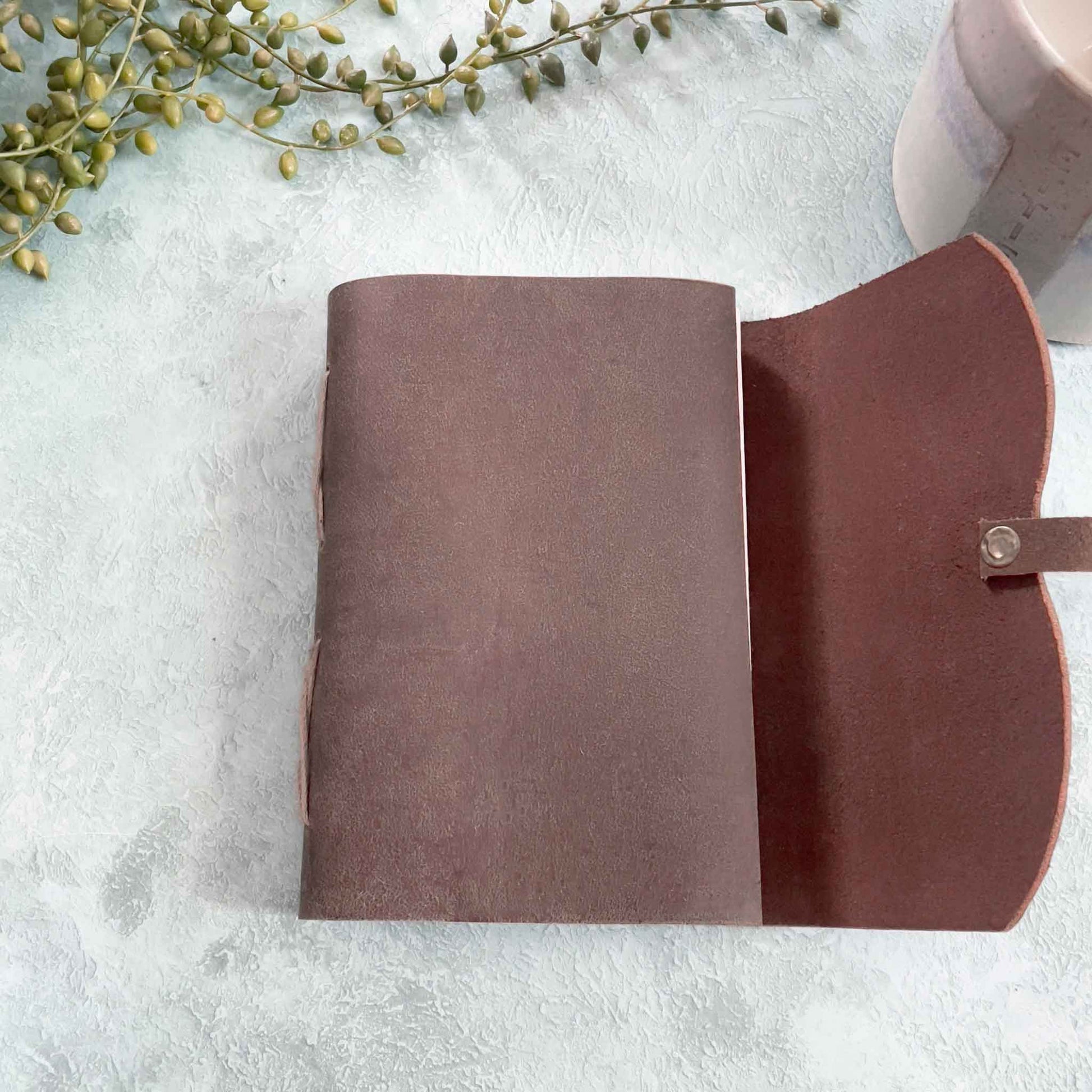 small leather notebook handmade from dark brown leather