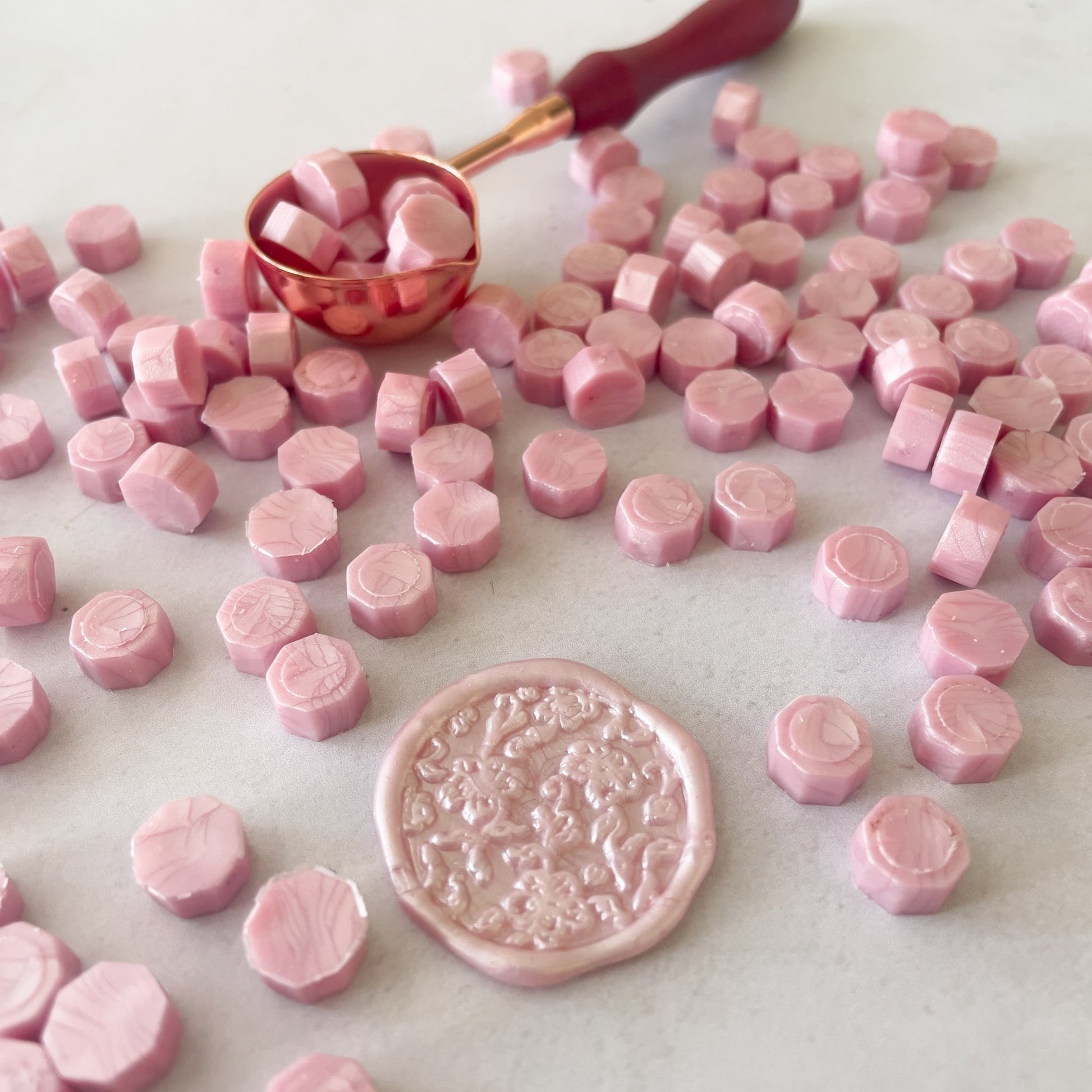 Sealing wax beads in soft pink.  Small beads of eco friendly sealing wax to make wax seals with a melting spoon and wax.  by The Natural Paper Company