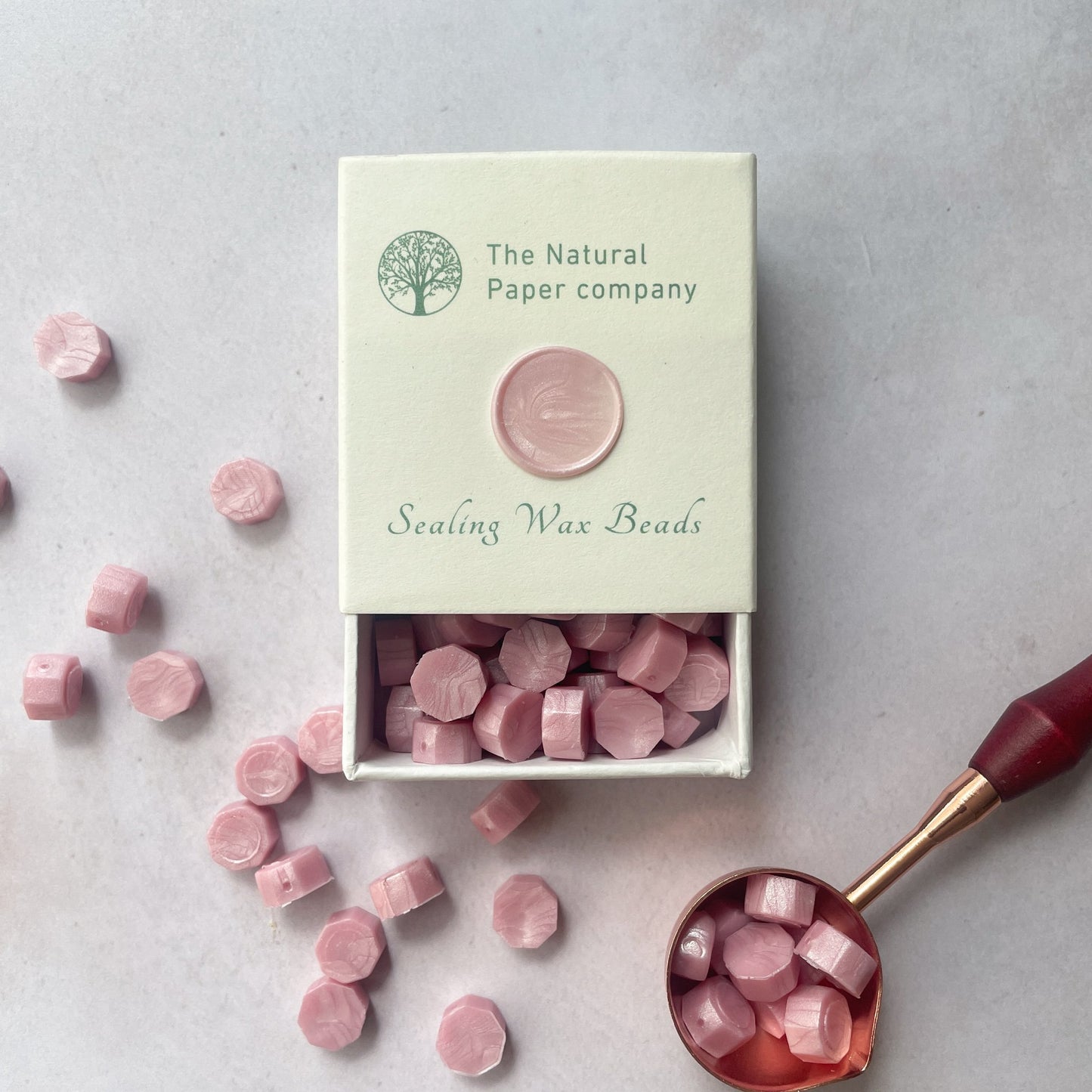 Box of sealing wax beads in pearlised pink.  Make eco friendly wax seals from pink wax seal beads.  Plastic free, paraffin free and biodegradable.  The Natural paper Company