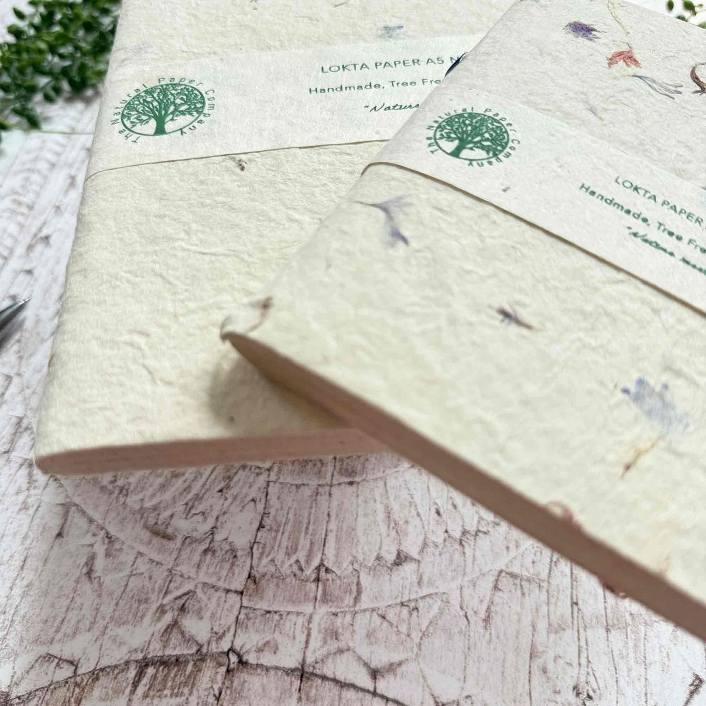 Side view of Cornflower Lokta notebooks, highlighting hand‑stitched binding and the natural grain of Lokta paper